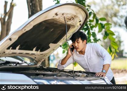 A man called a mechanic to fix the car because the car broke down.