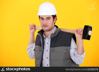 A man carrying a sledgehammer.