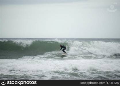 "A man catches a wave on his surfboard at an area called "The Point" in Jeffreys Bay."