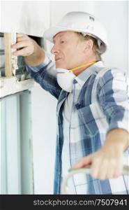 a man checking thermal insulation
