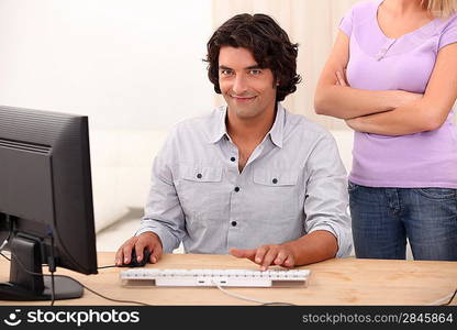 a man doing computer and an angry woman