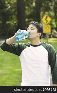 A man drinking water during his exercise