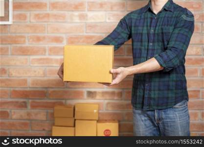 A man entrepreneur owner SME business is packaging box to send his customer