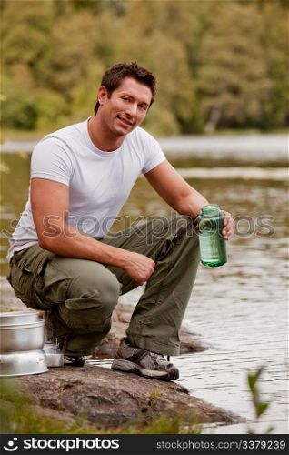A man fetching water on a camping trip