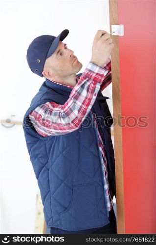 a man fitting door hinge