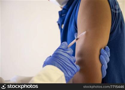 A man getting a doze of corona vaccine.