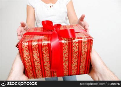 A man giving a christmas present to a woman