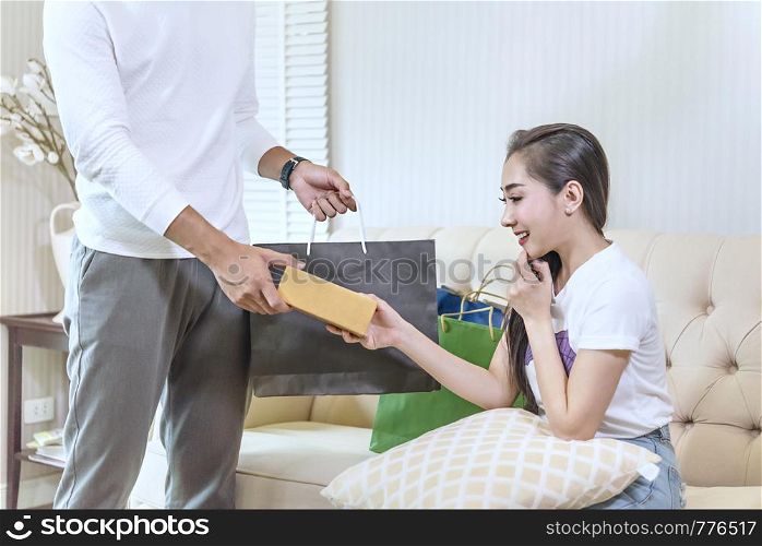 A man giving a present to beautiful woman. man giving a present to woman