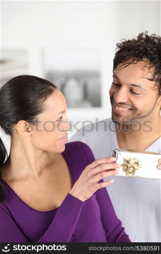 a man giving a present to his wife