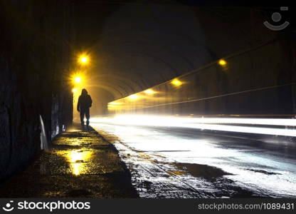 A man going through the dark tunnel