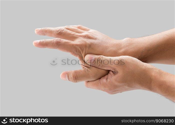 A man grab hand palm because the hand palm was injured. Hand pain. On a gray background.