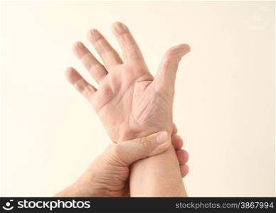 A man grips his painful wrist.