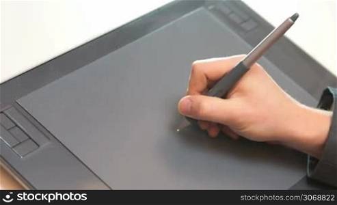 A man hand drawing on graphic tablet
