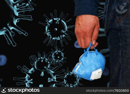 A man hand on coronavirusn background. Coronavirus pneumonia or flu concept. A man in the city with medical mask
