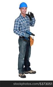 A man holding a driller.