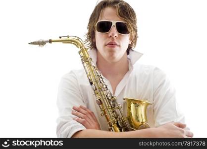 A man holding a saxophone between his crossed arms against a white background