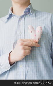 A man holds a heart in his hand