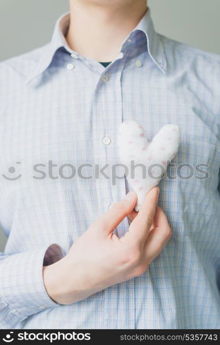 A man holds a heart in his hand