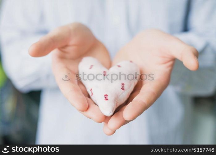 A man holds a heart in his hand