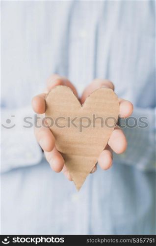 A man holds a heart in his hand