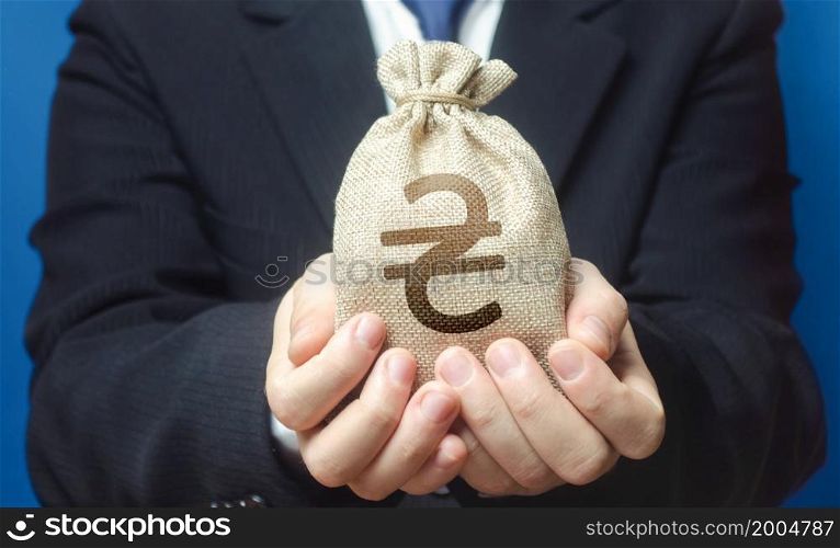 A man holds out a ukrainian hryvnia money bag. Trade, economics. Granting financing business project or education. Provision cash financial loan credit. Bank deposit. Budget management, tax collection