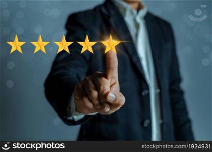 A man in a business suit gives a five stars rating. Rating increase concept, classification.