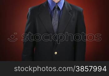 A man in a business suit in front of a red background holds up a light bulb and taps it as it flickers on. Off-centered version also available.