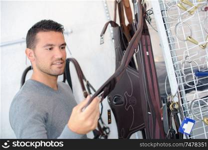 a man in a horse gear store