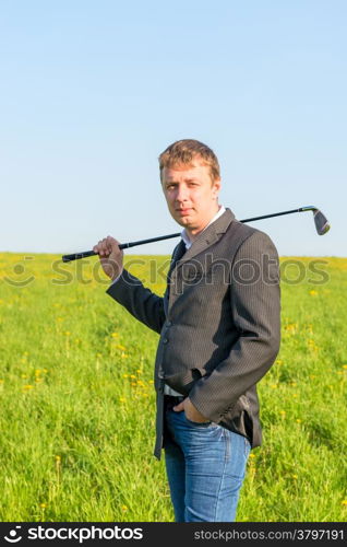 a man in a jacket and jeans going to play golf