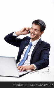 A man in a suit talking on the phone at your desk