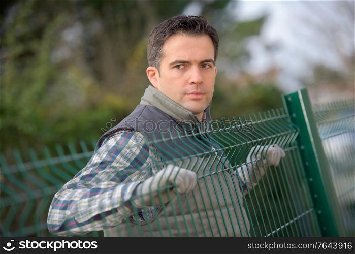 a man is a fencing erector worker