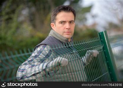 a man is a fencing erector worker