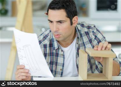 a man is assembling furniture close up