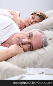 a man is awake when his wife is sleeping