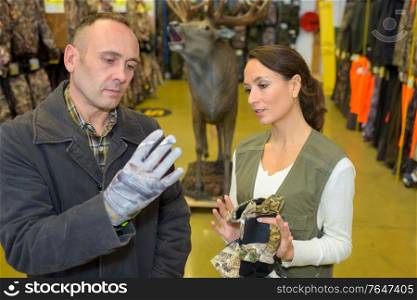a man is buying utility gloves