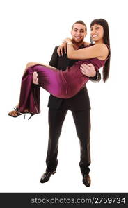 A man is caring his girlfriend, in a long burgundy dress, he in a blacksuit and both smiling, over white background.