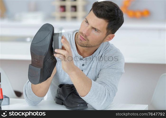 a man is cleaning shoes