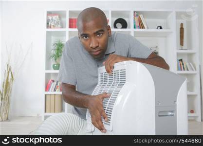 a man is fixing a portable heater