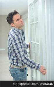 a man is installing a door