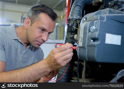 a man is repairing a machine