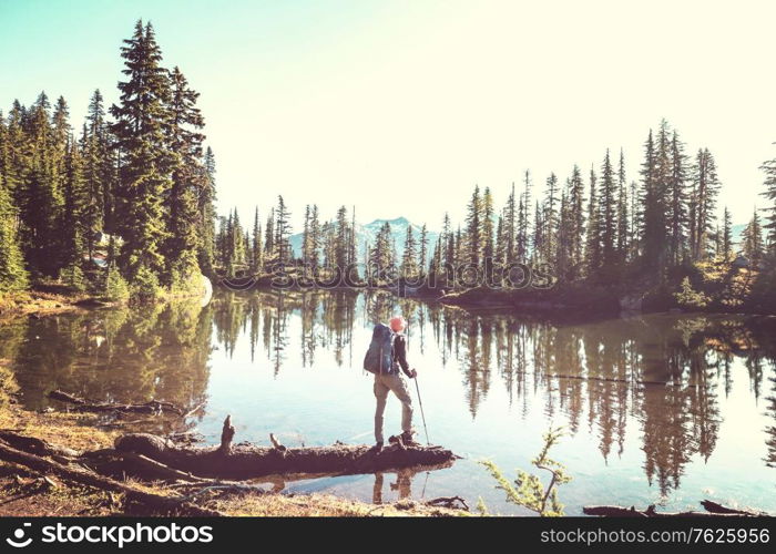 A man is resting at ease by the calm lake. Relaxation vacation