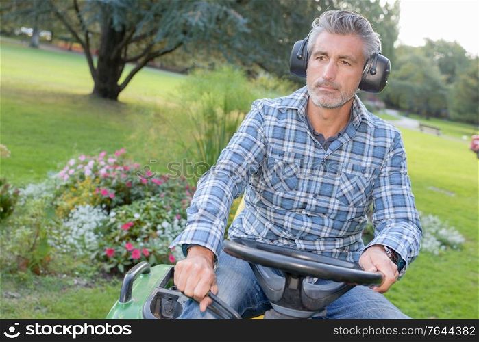 a man is sat on mower