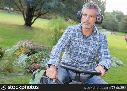 a man is sat on mower