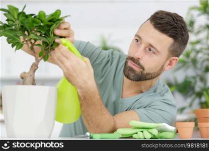 a man is trimming a bonsai
