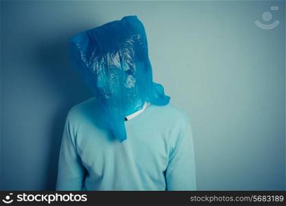 A man is wearing a plastic bag over his head