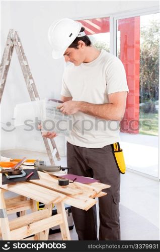 A man looking for a screw, doing home improvements