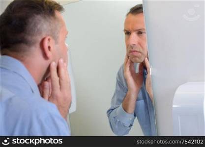 a man looking in mirror