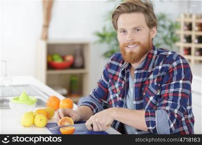 a man making orange juice