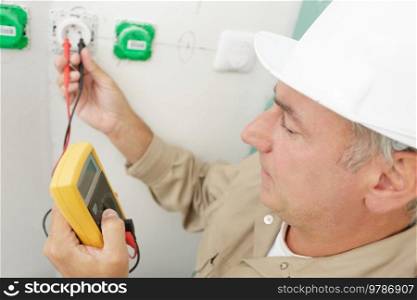 a man measures the voltage