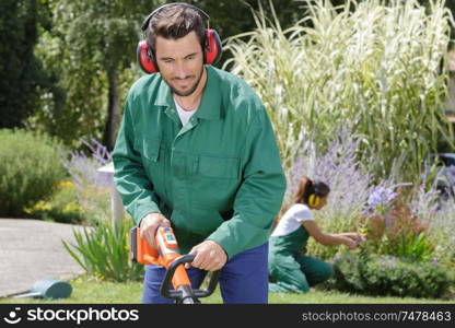 a man mows the grass